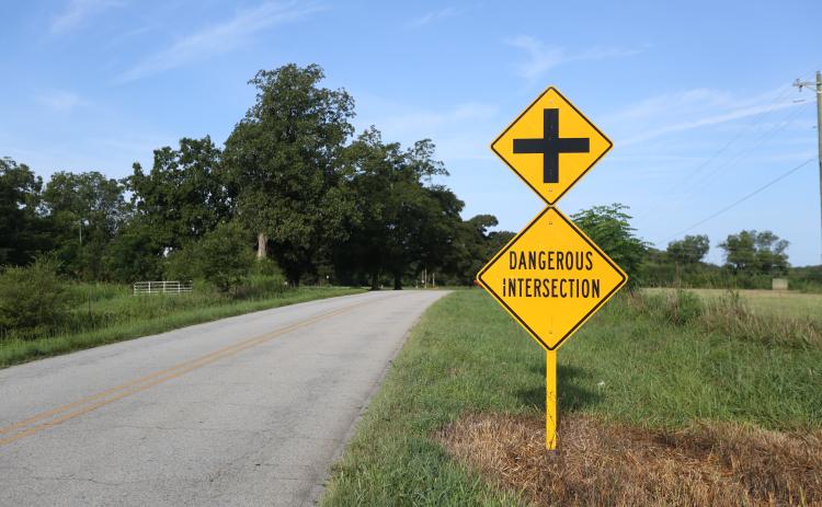 Dangerous intersection signs are posted on both sides of the road before the intersection of Liberty Hill and Liberty Hill Church roads, which is now set to become a four-way stop.  Photo by Rose Scoggins.