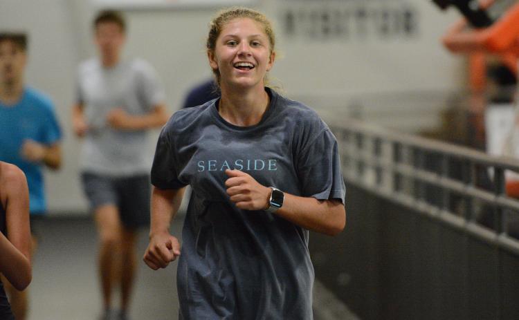 Freshman runner Posie Phillips jogs around the indoor track at the Hart County High School gym during a practice July 29. Photo by Benjamin London.