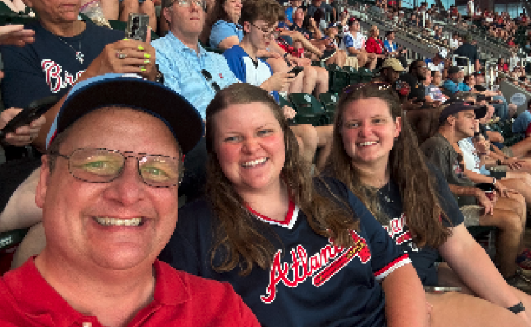 After three games of watching the Braves lose and two more with rain delays, we've decided our Scoggins family trio is cursed. We were able to get in this selfie before the rain poured last Thursday. Pictured are (L-R) Shane, Rose and Marlie Scoggins. Photo courtesy of Rose Scoggins.