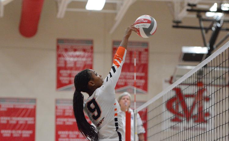 Pictured is middle Trinity Freeman, who goes up for a tip. Photo by Benjamin London.