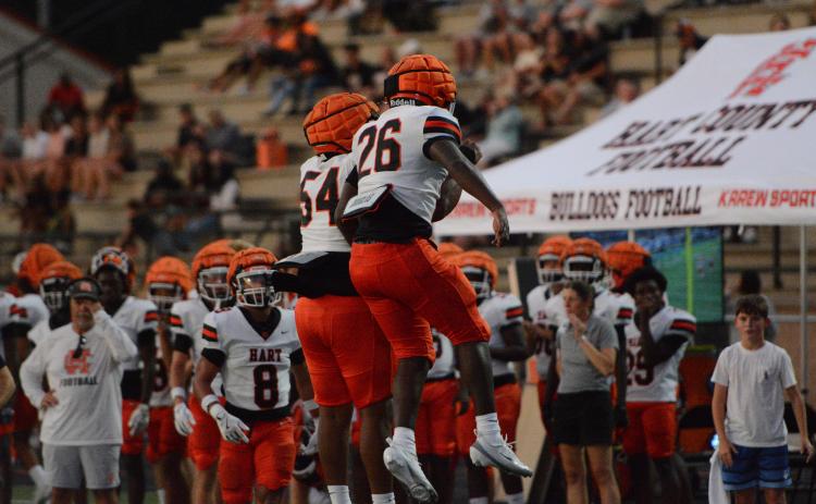 Junior running back Zeebo Harper (26) celebrates his touchdown run with junior lineman Kalik Pickens (54) in the 34-26 win over Oconee County Aug. 13. Photo by Benjamin London.