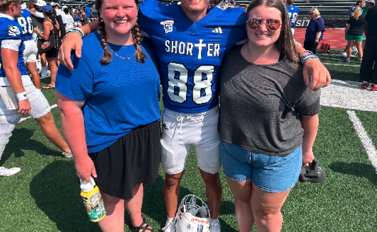 Pictured post-game with our "little" cousin Bryson (center), are Marlie (right) and me. Eight years younger than me and three younger than Marlie, Bryson is in his sophomore year at Shorter University. Photo courtesy of Rose Scoggins. 