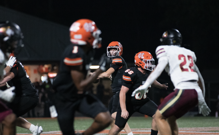 Pictured is sophomore quarterback Tucker Parson rearing back to throw to senior running back Xavier Allen for the opening touchdown for the Dogs.  Photo by Grayson Williams. 
