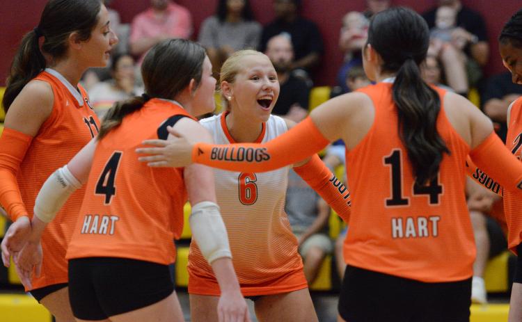 Junior libero Addison Coles (6) celebrates with her teammates after a point from a match earlier in the season, as the Volley Dogs are on a three-match win streak with wins over Morgan County, BASA and Lumpkin County. Photo by Benjamin London.