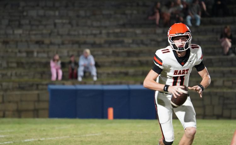Sophomore quarterback Tucker Parson keeps the ball on an option play, as he finished the game with 348 yards passing, four touchdowns and an interception through the air and 44 yards on the ground in the 36-30 win over Elbert County in the Granite Bowl Oct. 16. Photo by Kyle Tran.