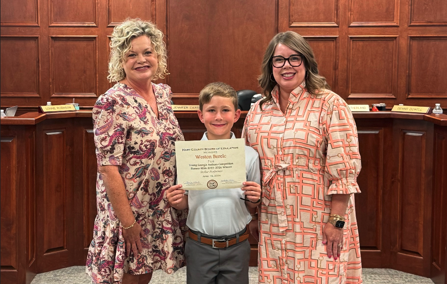 The Hart County Board of Education honored South Hart second grader Weston Berelc (center) as a Georgia Young Author Award winner. Berelc is pictured with Superintendent Jennifer Carter (left) and Board Chair Kim Pierce (right).