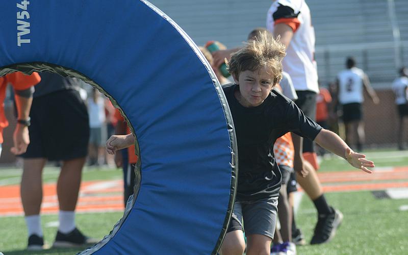 Cam Hart, 7, tries to tackle the tackle wheel.
