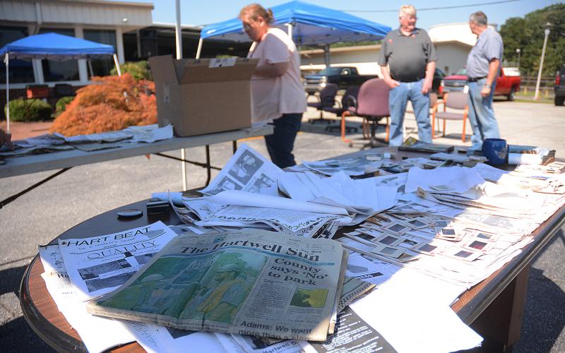 Items from a time capsule buried in 2006, including a copy of The Hartwell Sun, are displayed  at a table during a recent employee event at the Tenneco facility in Hartwell.