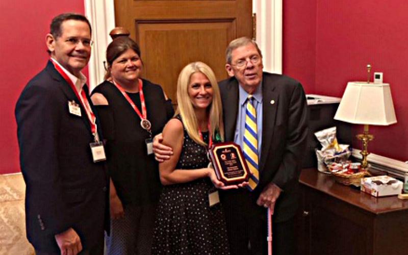 Photo submitted — Truck Safety Coalition executive director Harry Alder, from left to right, Hart County resident and coalition member Vickie Johnson and coalition member Pam Biddle present an award to U.S. Sen. Johnny Isakson recently in Washington D.C.