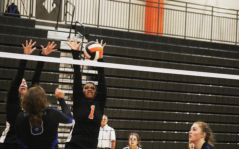 Perrisha Allen goes for a block during the match.
