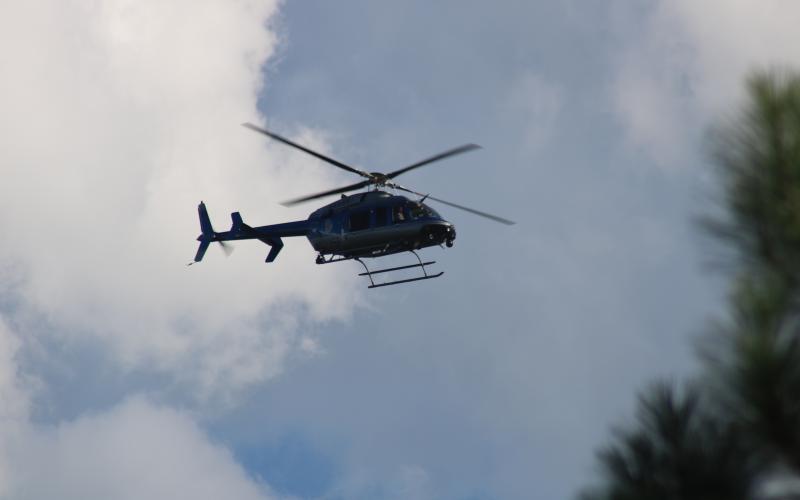 Sunshot by Grayson Williams — A Georgia State Patrol helicopter aids local law enforcement in a search for a man who ran during the execution of a search warrant on Liberty Hill Church Road.