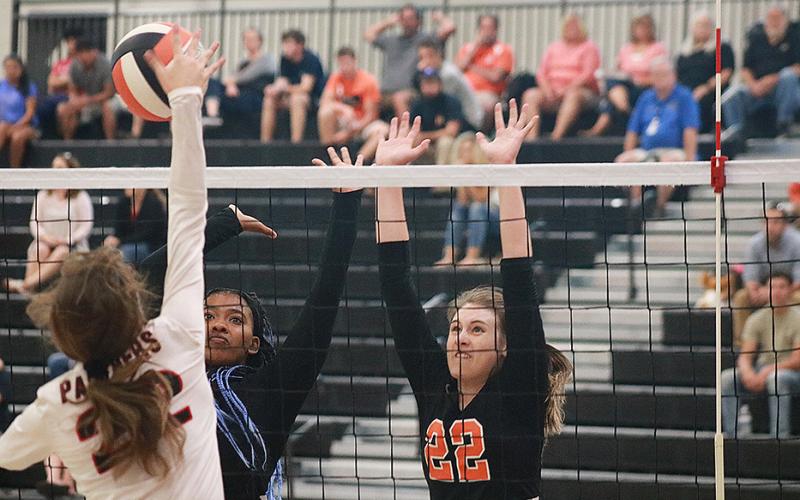 Sunshot by Grayson Williams — Hart County Volleydogs Perrisha Allen and Madison Wolfe go for the block against Jackson County on Sept. 5 at Hart County High School.
