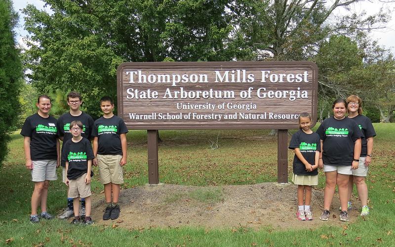 Photo submitted — 4-H’ers pose for a photo at the Thompson Mills Forest State Arboretum in Braselton. They are, from left to right, coach Ruth Daniel, Kaleb Waddell, Charlie Jones, Ashleigh Jones, Emma Shiflet, coach AnnaMarie Harrison. Standing in front is Aric McBride.