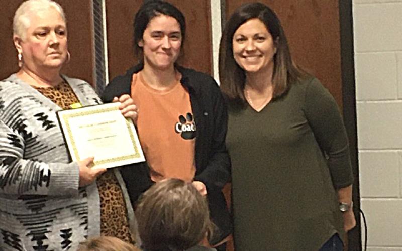 Denise Childs, left, and Nicole Wheless, right, present special education teacher Ashley Mccurley with a certificate for the Joey Childs Classroom Grant. Photo submitted