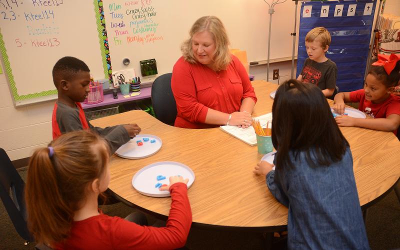 Sunshot by Michael Hall — Teacher Kathleen Teel, center, works with second-grade students recently at South Hart Elementary. 
