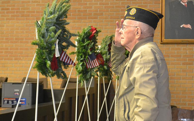 Sunshot from file — World War II Army veteran Harold “Andy” Anderson salutes during the presentation of the Wreaths Across America in December 2018 at the Hart County Courthouse.