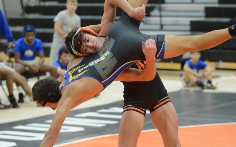 Sunshot by Grayson Williams - Hart County’s Ayers Honiotes takes down a Washington-Wilkes opponent at Hart County High School on Dec. 4.