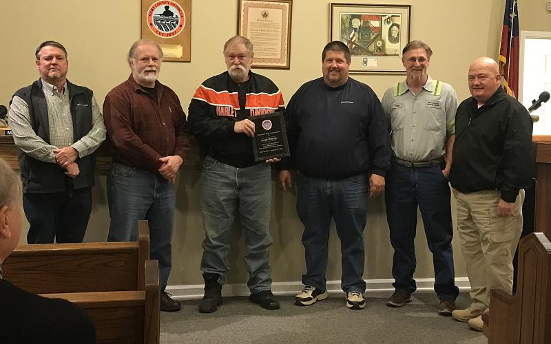 Joe Brantley, who is retiring, was awarded a plaque for his service as a long-time employee of the county. Pictured are county commissioners Ricky Carter, from left, and Marshall Sayer, Brantley, commission chairman Joey Dorsey, solid waste department head Greg Howell, and commissioner Frankie Teasley.