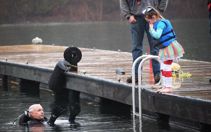 File photo submitted by Barbi Stowe - Aubrey Bailey, then 6, needed a little persuasion from safety diver Kinsey Craft to jump into the 54-degree water of Lake Hartwell at the 2019 Polar Bear Plunge, a benefit for the Northeast Georgia Council on Domestic Violence.