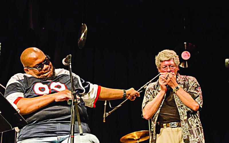 Photo submitted by Stephanie Crump - Walter Gordon, right, plays his harp on stage at High Cotton Music Hall in Hartwell recently with The Big C Clarence Cameron. 