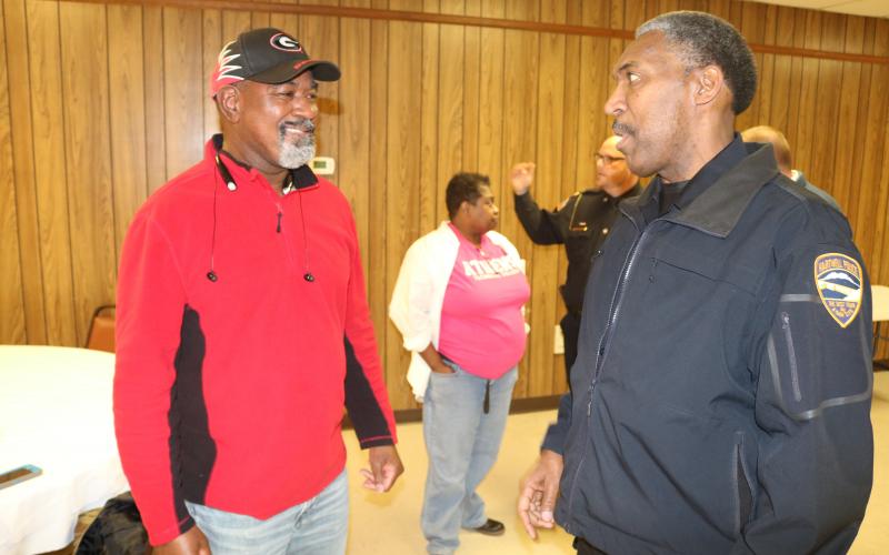 Sunshot by Grayson Williams - Hartwell Police chief Anthony Davis, right, talks to Paul Simpson, left, at the GBI’s gang awareness event on Jan. 16 in Lavonia. 