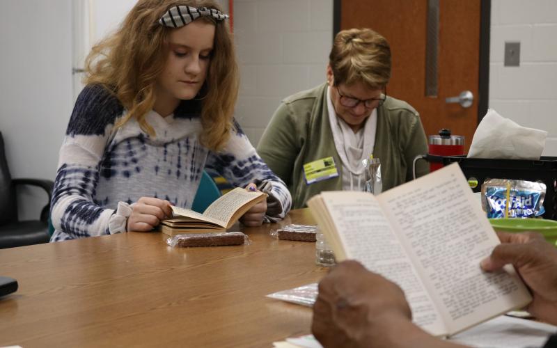 Sunshot by Grayson Williams - Abigail Ricketts, left, and Linda Mealor, right, read during a book club meeting at Hart County Middle School, organized by Hart Partners, reads “Where the Red Fern Grows” on Friday, Feb. 14 at the Middle School.