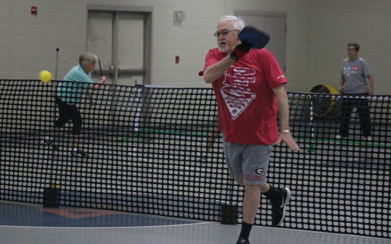 Sunshots by Grayson Williams - Paul Martin, above, volleys during a pickleball game at the Bell Family YMCA in Hartwell on Tuesday.