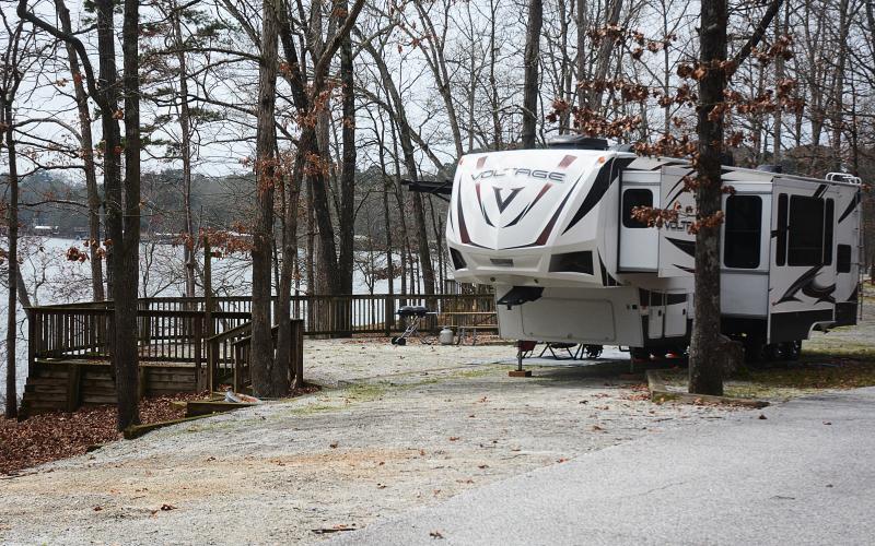 Sunshot by Michael Hall — A fifth-wheel camper is parked at a campsite at what was Hart State Park, and is becoming Hartwell Lakeside. Campground renovations are the first phase of the transformation. 