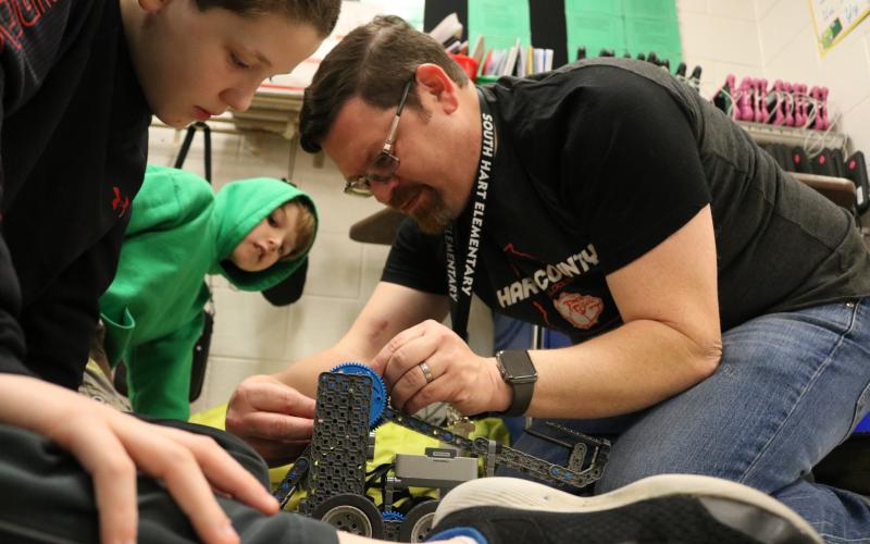 Sunshot by Grayson Williams - South Hart Elementary fifth-grade teacher Josh McCurley, right, works on a robotics project with students recently. McCurley was recently honored as a Georgia STEM Scholar.