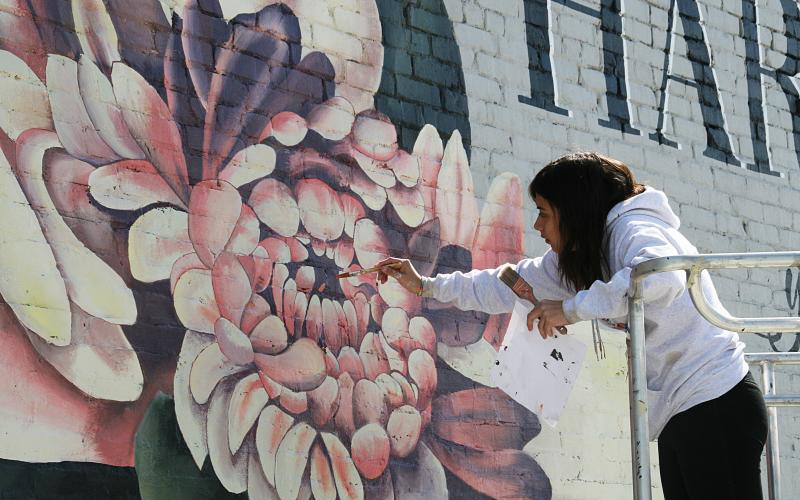 Arevalo puts some of the finishing touches in center of the bloom. 