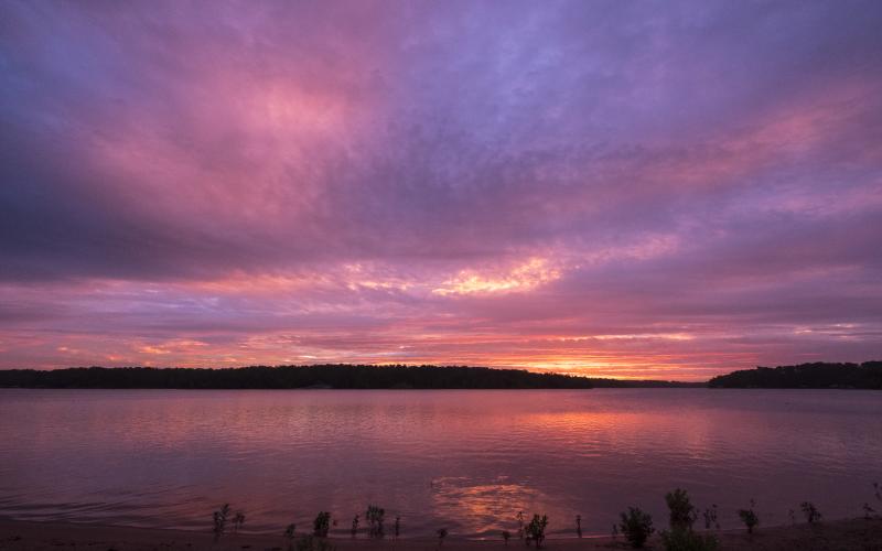Sunshot by Bill Powell — An array of colors light up the sky at dawn on Saturday, June 26, over Lake Hartwell.