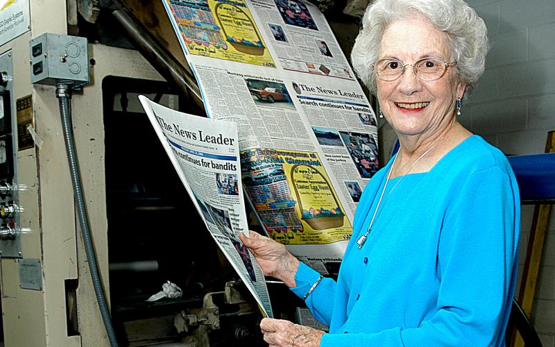 Sunshot from file by Bill Powell — Wassie Vickery holds a newspaper fresh off the press at The Hartwell Sun in 2006. 