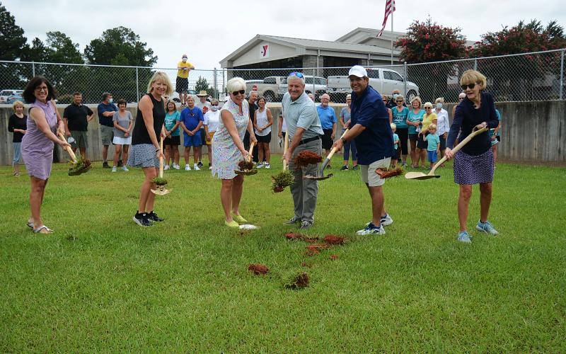 Sunshot by MIchael Hall - Above, Bell Family YMCA director Mandy Floyd, from left to right, and Lake Hartwell Pickleball Club members Angie Putman, Henley Cleary, president Eddie McCurley and Peggy Vickery break ground on what will become the club’s outdoor courts at the YMCA in Hartwell on Monday, Aug. 24.