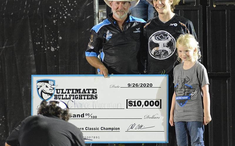Chance Moorman, of Lytle, Texas, center, accepts a check for $10,000 from Chad Ellison for winning the UBF Southern Classic in Bowersvile on Saturday, Sept. 26. 
