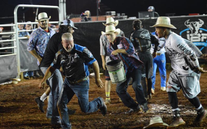 Bullfighters throw water on Chad Ellison, of Chad Ellison Fighting Bulls and Franklin County Livestock after the competition to celebrate Ellison’s birthday. 