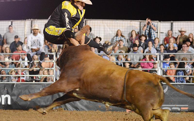 Alex McWilliams, of Paso Robles, Calif., attempts to jump over a bull charging out of the gate, but didn’t quite make it. McWilliams needed medical attention from paramedics after the maneuver, but was not seriously injured.  