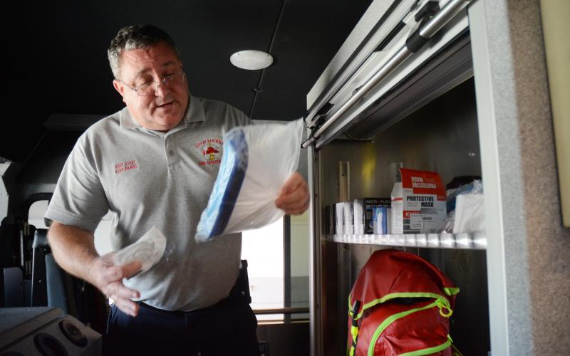Sunshot by Michael Hall - Hartwell acting fire chief Alan Daniel goes through some personal protection equipment on the city’s new fire truck that the department uses during the COVID-19 pandemic. 