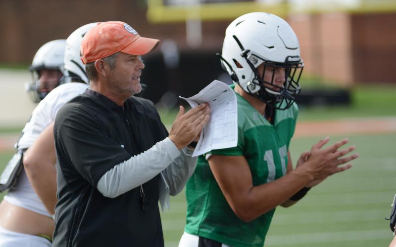 Sunshot by Michael Hall - Hart County Head Coach Rance Gillespie, left, breaks from a huddle with his team, including starting quarterback Austen Whitworth, during an intrasquad scrimmage on Friday, Aug. 29, at Herndon Stadium.  
