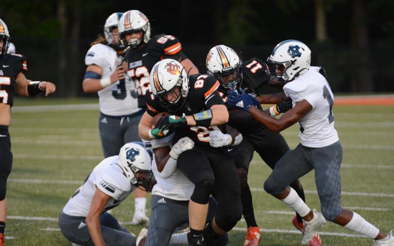 Cane Berrong fights off White County tacklers at Herndon Stadium on Sept. 11. 