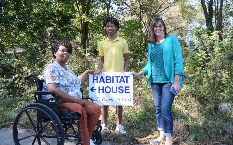 Sunshot by Grayson Williams - Yolanda Feaster, left, and her son, C.J., pose for a photo with Darlene Nixon, Hart Habitat for Humanity executive director Darlene Nixon, right, at the site of what will be the Feasters’ new home. 