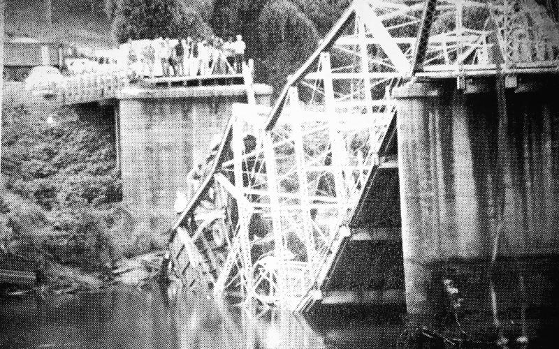 The Smith-McGee Bridge is shown collapsed in 1982.