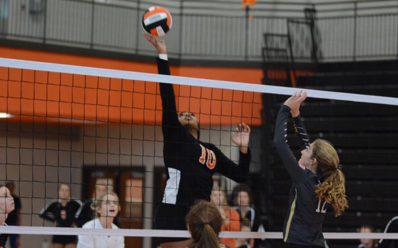 Sunshot by Grayson Williams- Nesha Alexander hits the ball at the net on Oct. 1 at Hart County High School.