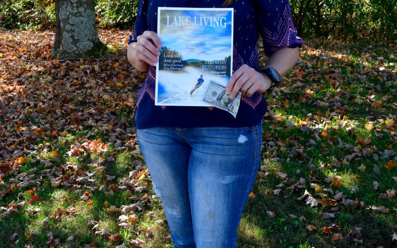 Photo by Kimberly Brown - Heather Conner, of Clayton, holds a copy of the cover of Lake Living Magazine and her $100 in prize money she won in a photo contest for the cover shot. 