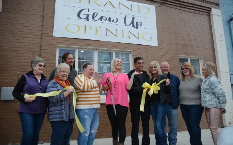 From left to right, TORCH board of directors members Nancy Butler, Mary Gidley and Joe Hoffman, Glow Up partners Laura McCarty and Jessica Fortson, Downtown Café owner Sharif Farhan and manager Melissa Dove, Hartwell city councilman Tray Hicks, Lake Hartwell Insurance’s Elizabeth Brewer and Winnie J’s owner Winnie Sullivan celebrate the ribbon cutting for Glow Up Tanning Salon, 47 Depot Street in downtown Hartwell. 