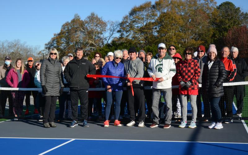 Sunshot by Michael Hall In the front row, Angie Putman, CEO of YMCA of Georgia’s Piedmont, Joby Scroggs, Henley Cleary, Eddie McCurley, Frank Gunder, Kathy McCurley and Bell Family YMCA director Mandy Floyd cut the ribbon on new outdoor pickleball courts at the YMCA with Lake Hartwell Pickleball Club members behind them