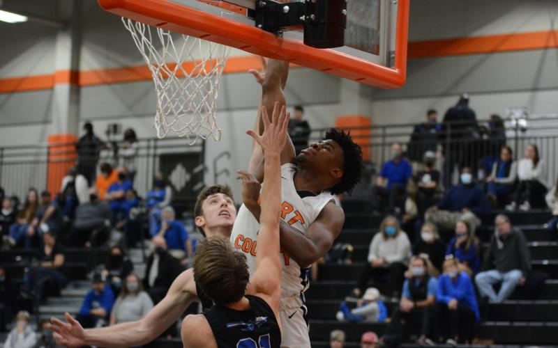 Sunshot by Grayson Williams - Hart County’s Tahj Johnson posterizes two Oconee County players by dunking on them Friday, Jan. 22, at Hart County High School. 