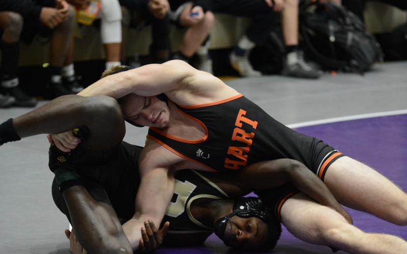 Hart County’s Nate Bennett rolls with a Rockmart opponent on Saturday, Jan. 30 at Cherokee Bluff High School in Flowery Branch. The Mat Dogs finished sixth in the state in the Class AAA duals wrestling tournament. 