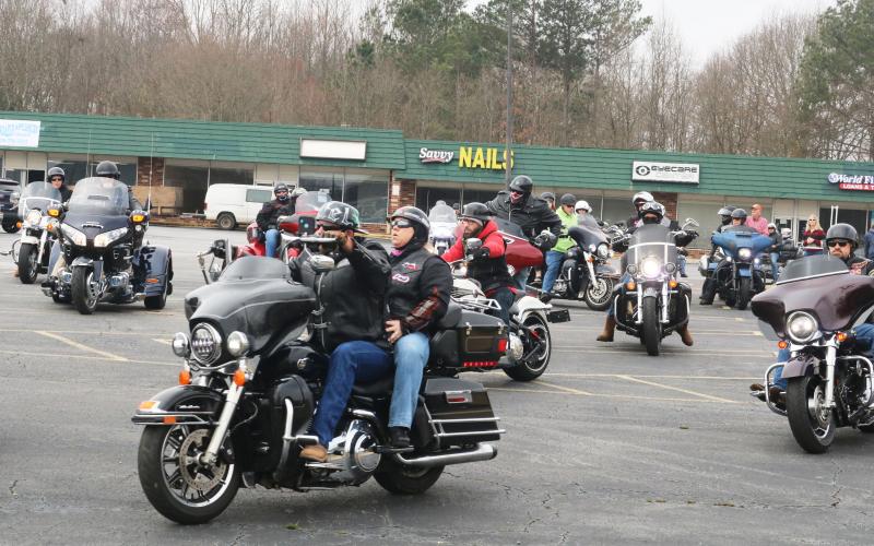 Motorcyclists leave the parking lot of the Quality Foods parking lot on Saturday, Feb. 27, for the Women Ride, Women Build motorcycle ride.