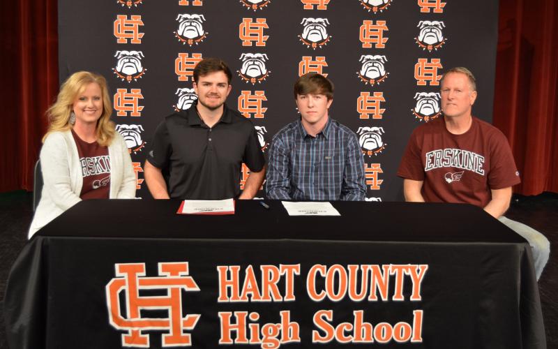 Sunshot by Drew Dotson - Max Heaton, second from right, poses for a photo with his parents Kevin, far right, and Jennifer Heaton, far left, alongside Erskine head bass fishing coach Ryan Teems, second from left, after Max signed a letter of intent on Friday, April 2 at Hart County High School to fish collegiately for Erskine College.