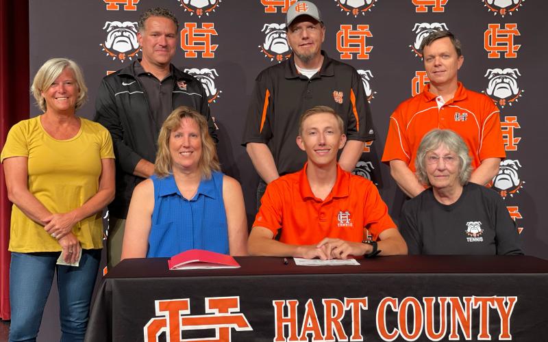 Chase “C.J.” Jorensen, seated center, signed to Mars Hill’s tennis team alongside, seated left, mother Kathleen Jorensen, seated right, grandmother Janice Yaple, standing from left, coach Cheryl Tierney, coach Lloyd Martin, father Kenny Jorensen and coach Kevin Harris.